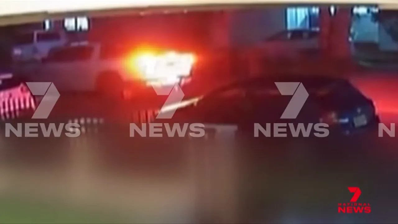 Security footage screenshot showing a bright flash during a gunpoint kidnapping outside a Bass Hill home
