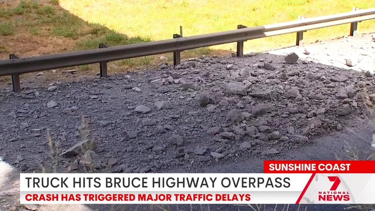 Concrete rubble and debris on the southbound Bruce Highway carriageway after overpass collision