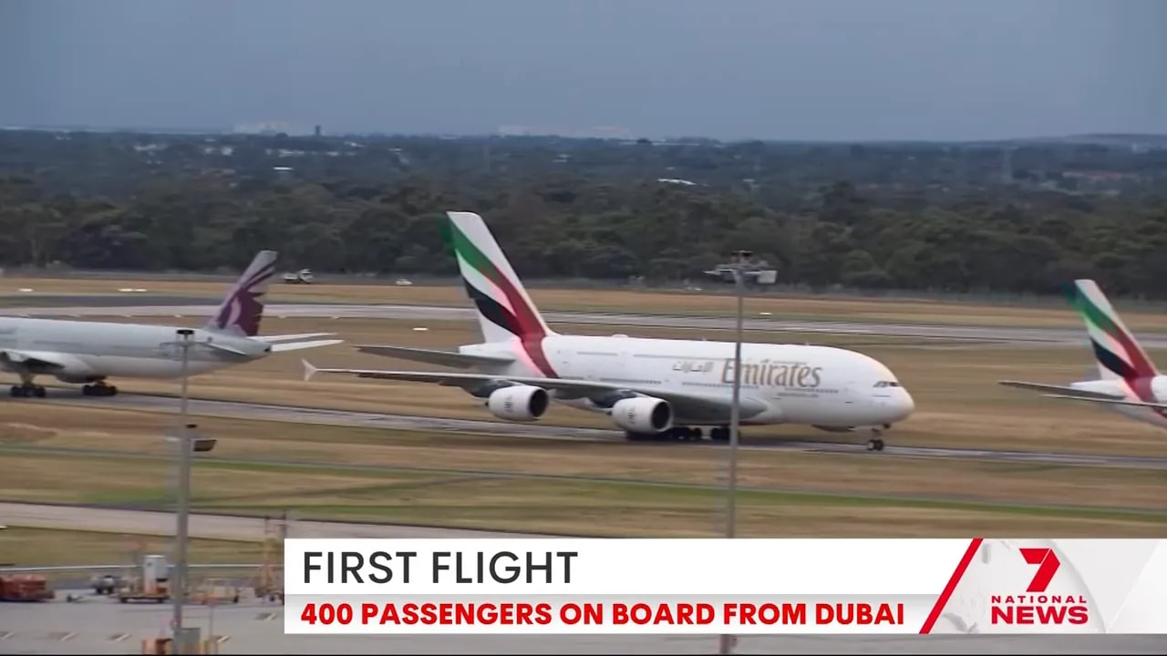 Close, clear view of an Emirates A380 taxiing on the runway with another Emirates and Qatar aircraft nearby.