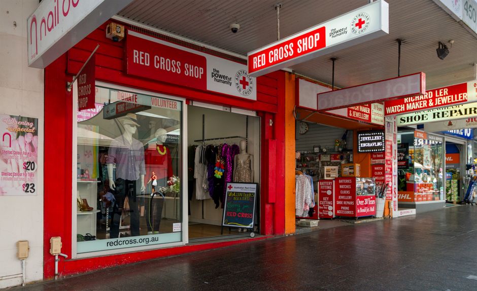 Exterior view of the Red Cross Shop in Bondi Junction, featuring clothing and signage.