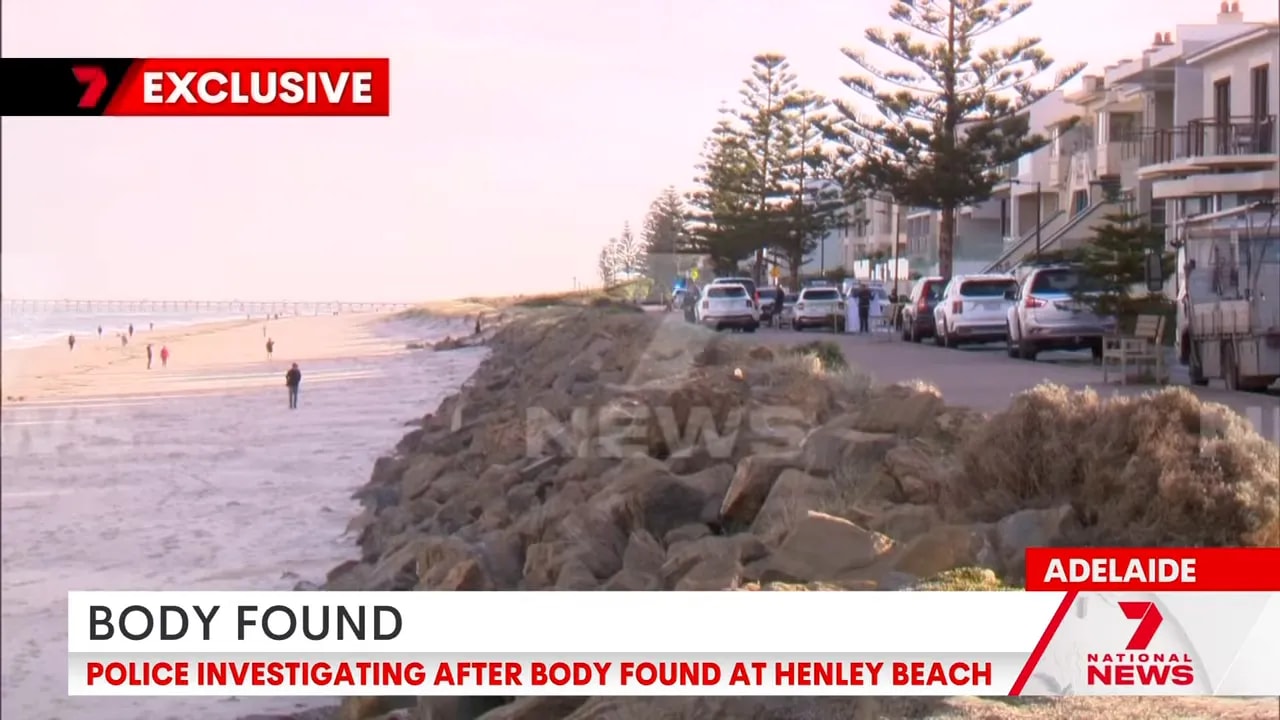 Henley Beach waterfront and parked emergency vehicles during body found investigation