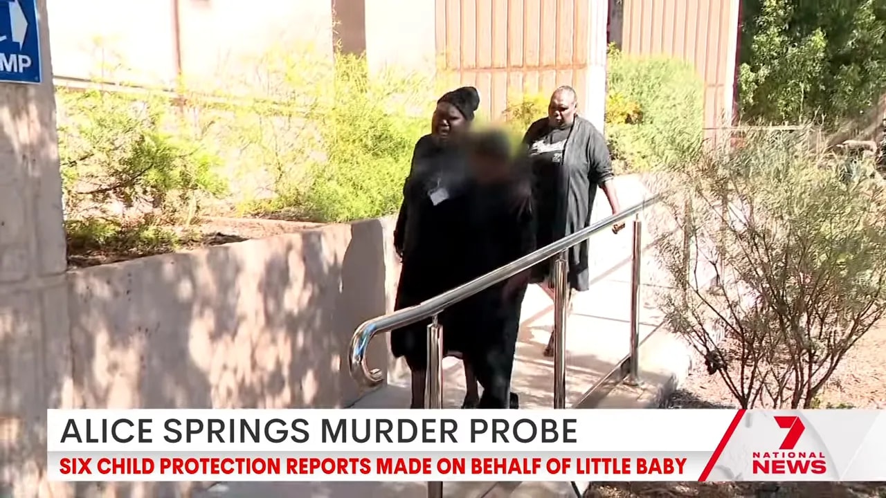 News screenshot of investigators outside during the Alice Springs murder probe with banner referencing six child protection reports