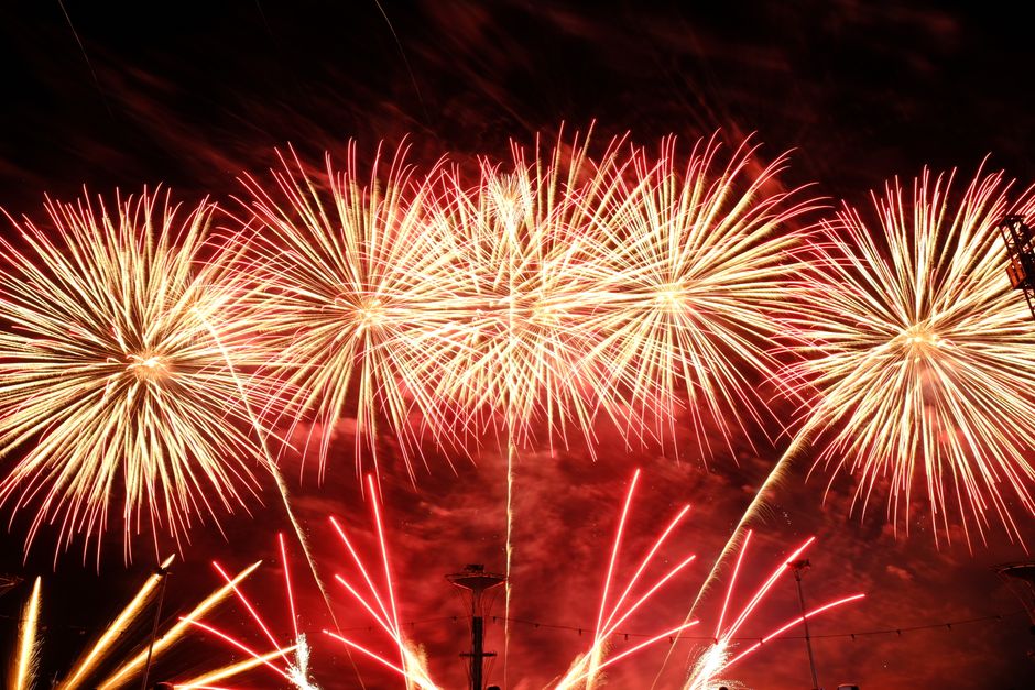 Spectacular fireworks lighting up a clear night sky in vibrant colors.