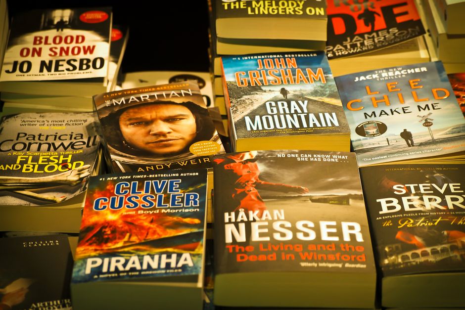A collection of bestselling thriller novels prominently displayed in a bookstore setting.